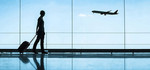 woman pulling luggage in airport